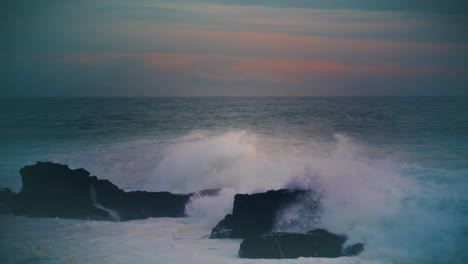 storm ocean hitting coastal rocks at dark skyline. breathtaking evening seascape