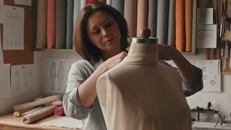fashion designer working on a garment on a mannequin