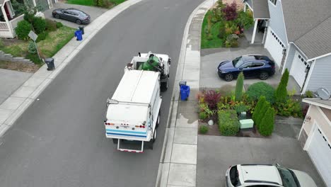 aerial shot of a waste management truck picking