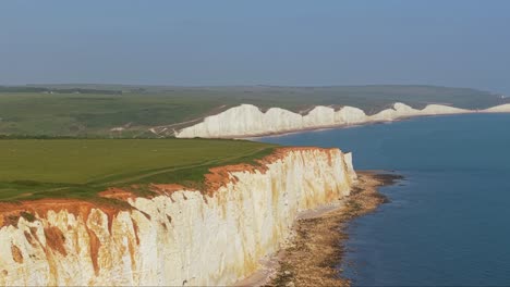 drone ascends to reveal the stunning chalk cliffs of the seven sisters and the dramatic coastal landscape of southern england