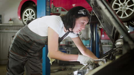 woman repairing car