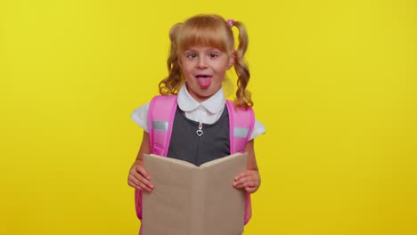 smiling schoolgirl hiding behind a book laugh fooling around making playful silly facial expressions