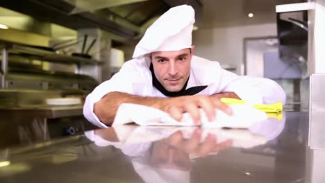 handsome chef wiping down the counter