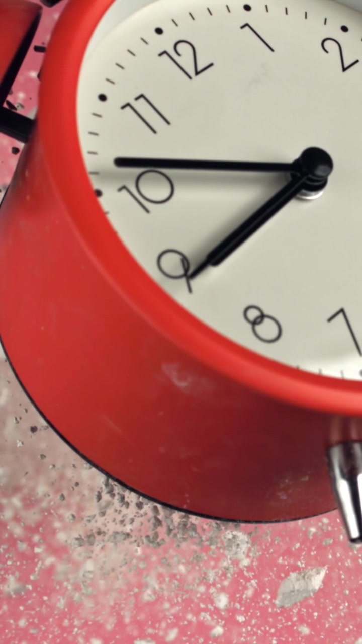 Red Alarm Clock Ticking on a Glittery Pink Background