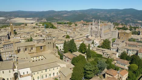 Drone-Desciende-Con-La-Catedral-De-Orvieto-En-Segundo-Plano-El-Día-De-Verano