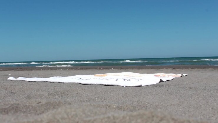 Giovane uomo che dorme sulla spiaggia 3