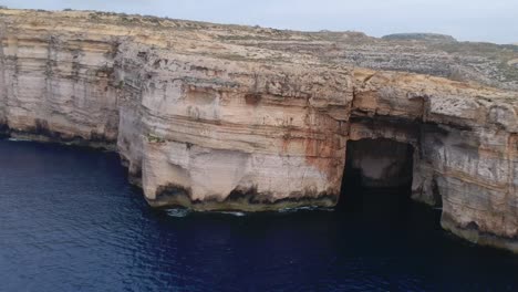 aerial flight along rocky cave ocean