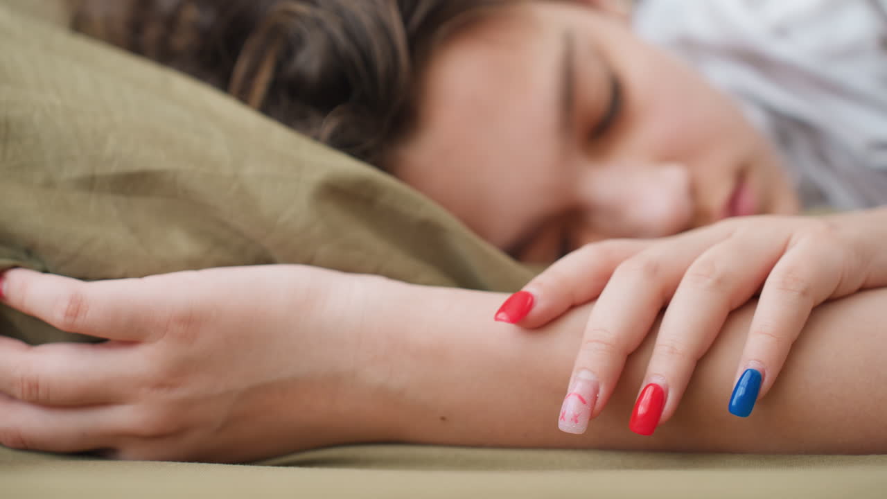 Scene Of Peaceful Person Sleeping With Vibrant Nails Alone At Home, Tranquil Scene Showing Someone Resting On Furniture With Colorful Nails Under Soft Natural Light In Cozy Environment