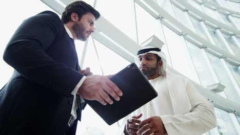 western caucasian arabic male businessmen meeting using tablet