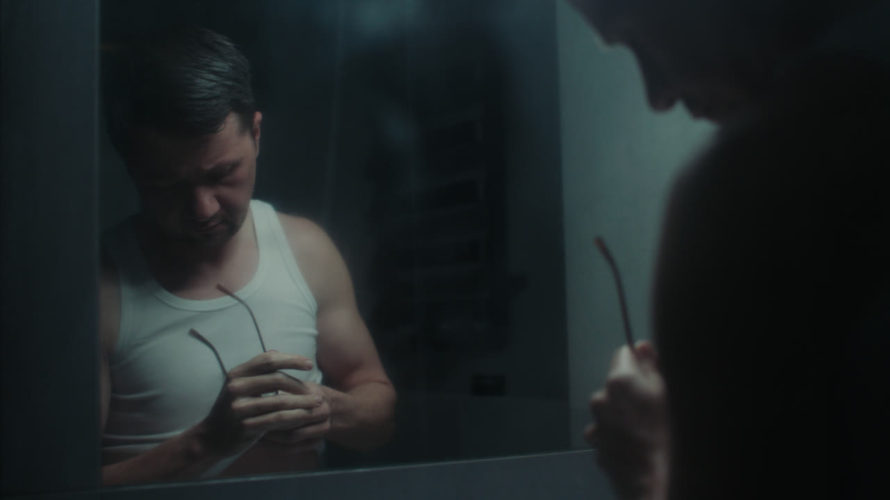 A sad man in the bathroom during his morning routine