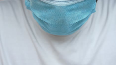 person wearing a blue face mask