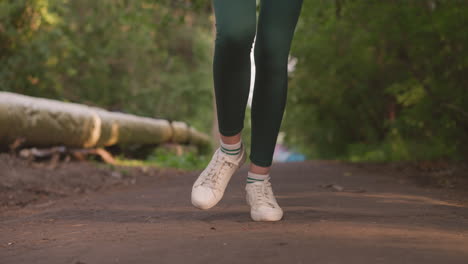 woman walking on a path in a forest