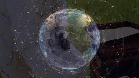 man holding floating holographic earth globe, illustrating technology network lines and data points