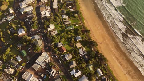 aerial view of the beach houses at oneroa bay on waiheke island, new zealand.