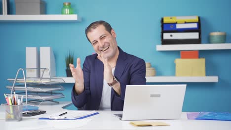 excited businessman clapping at camera.