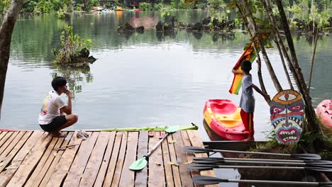 person sitting by a serene waterway