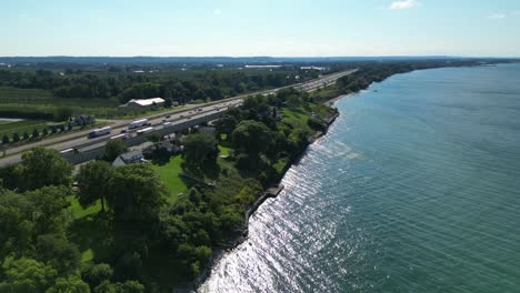 reveal shot of highway in lincoln along lake, aerial