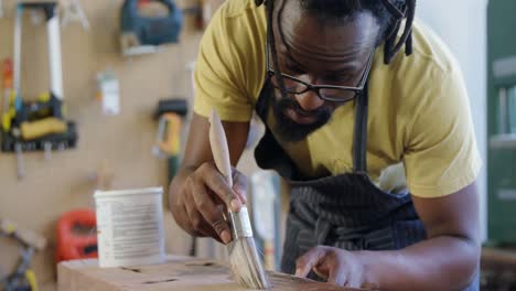 attentive carpenter painting wooden plank 4k