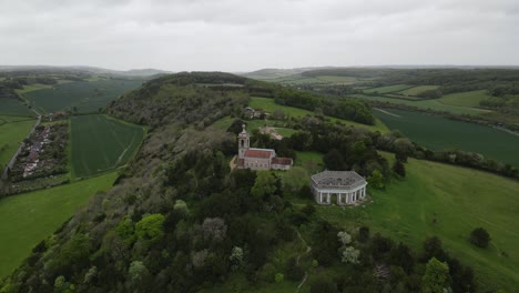 west wycombe hill famous landmark, st lawrence church bucks uk aerial point of view footage