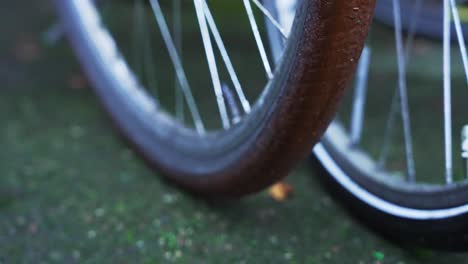 slow motion camera pan over backwheel spokes of an oldschool locked bicycle