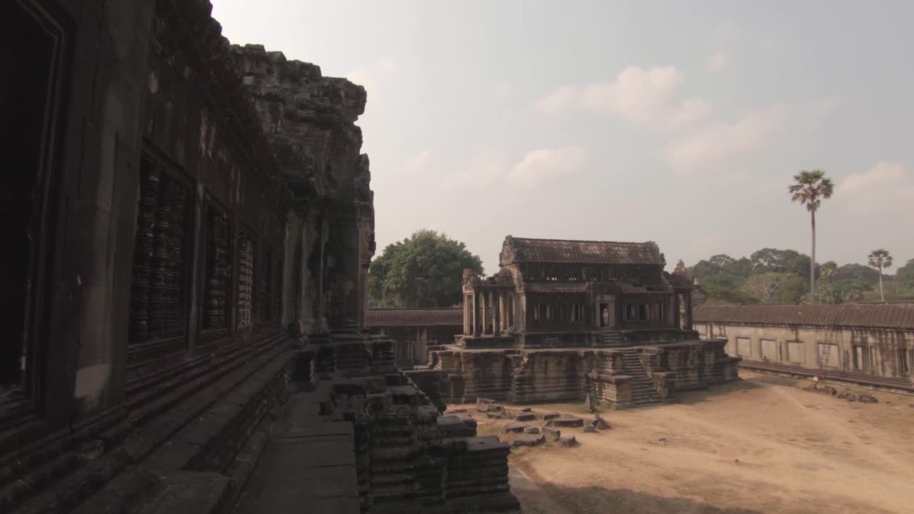 Famous ruins of Angkor Wat temple complex in Cambodia. Cinematic panning shot