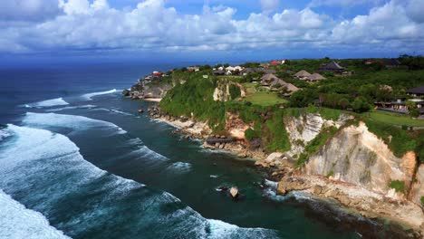 Ocean-Waves-Approaching-Coastal-Cliff-Of-Uluwatu-On-A-Cloudy-Day-In-Bali,-Indonesia