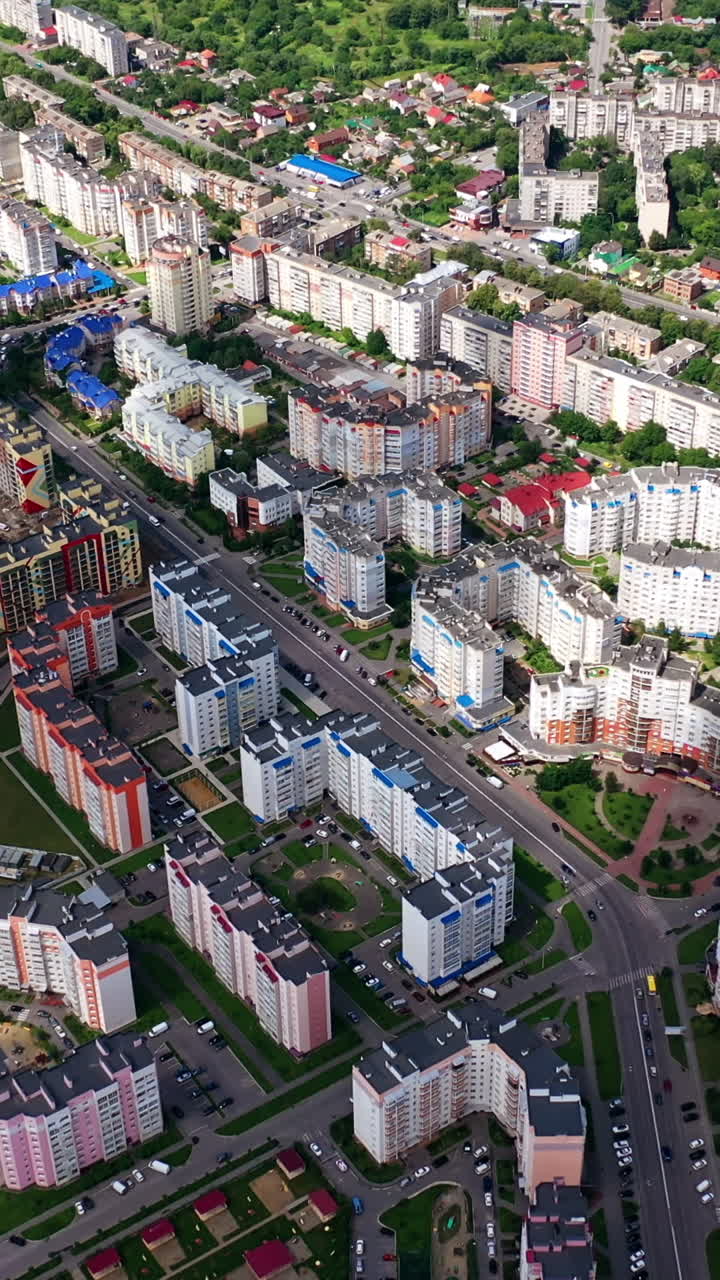 High-rise buildings in the city. Modern architecture on the urban background. Amazing view of a cityscape. Top down view. Vertical video