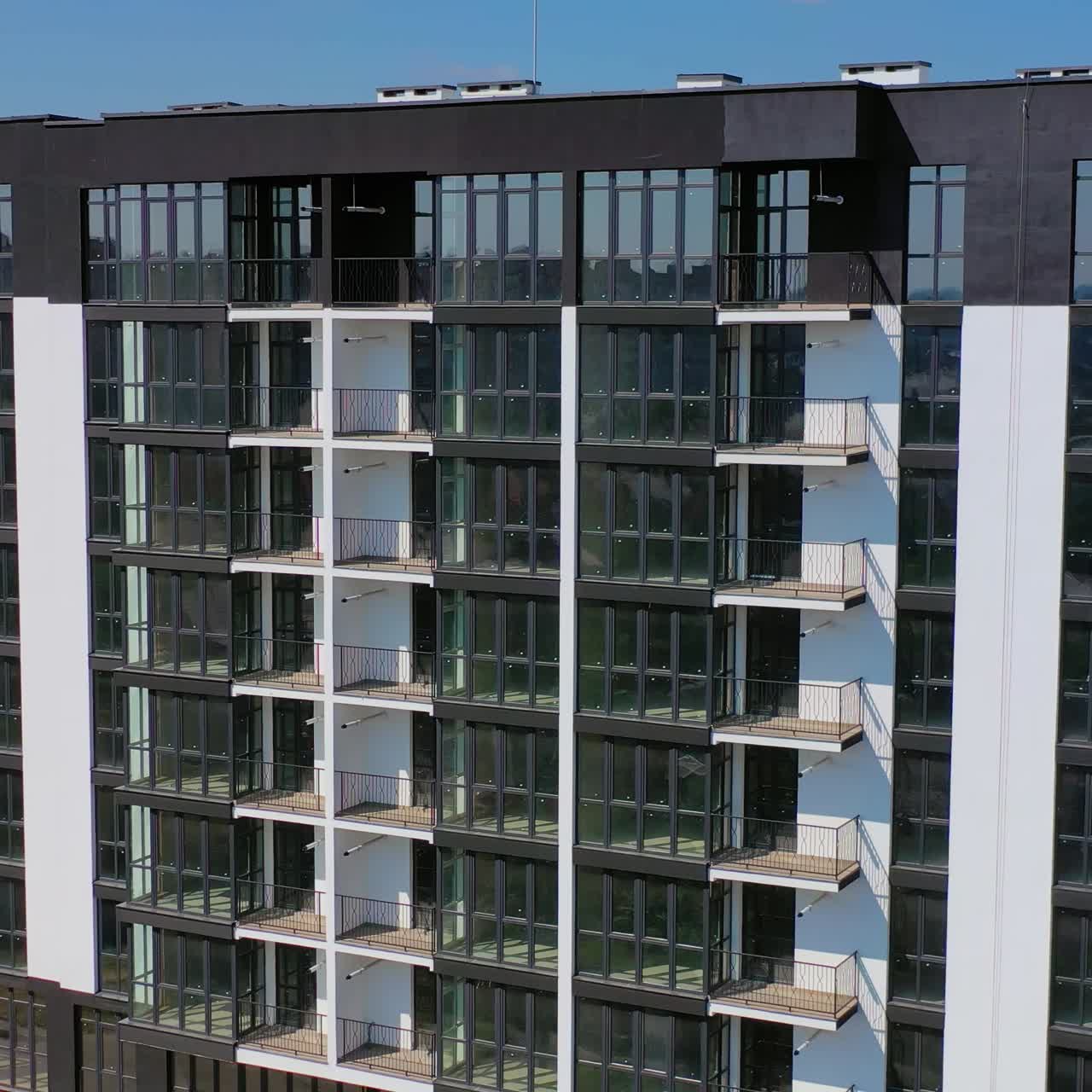 New high-rise residential building in city suburb. New apartment houses. Video of modern buildings.