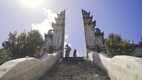 tourist couple at the top of a staircase atpura lepmuyang temple