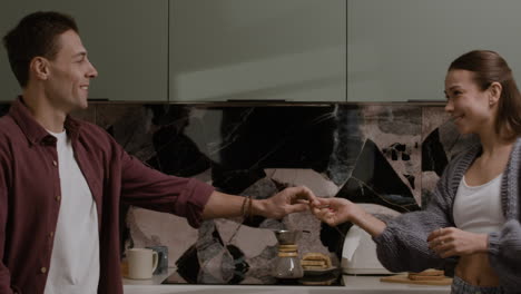 happy couple dancing in the kitchen
