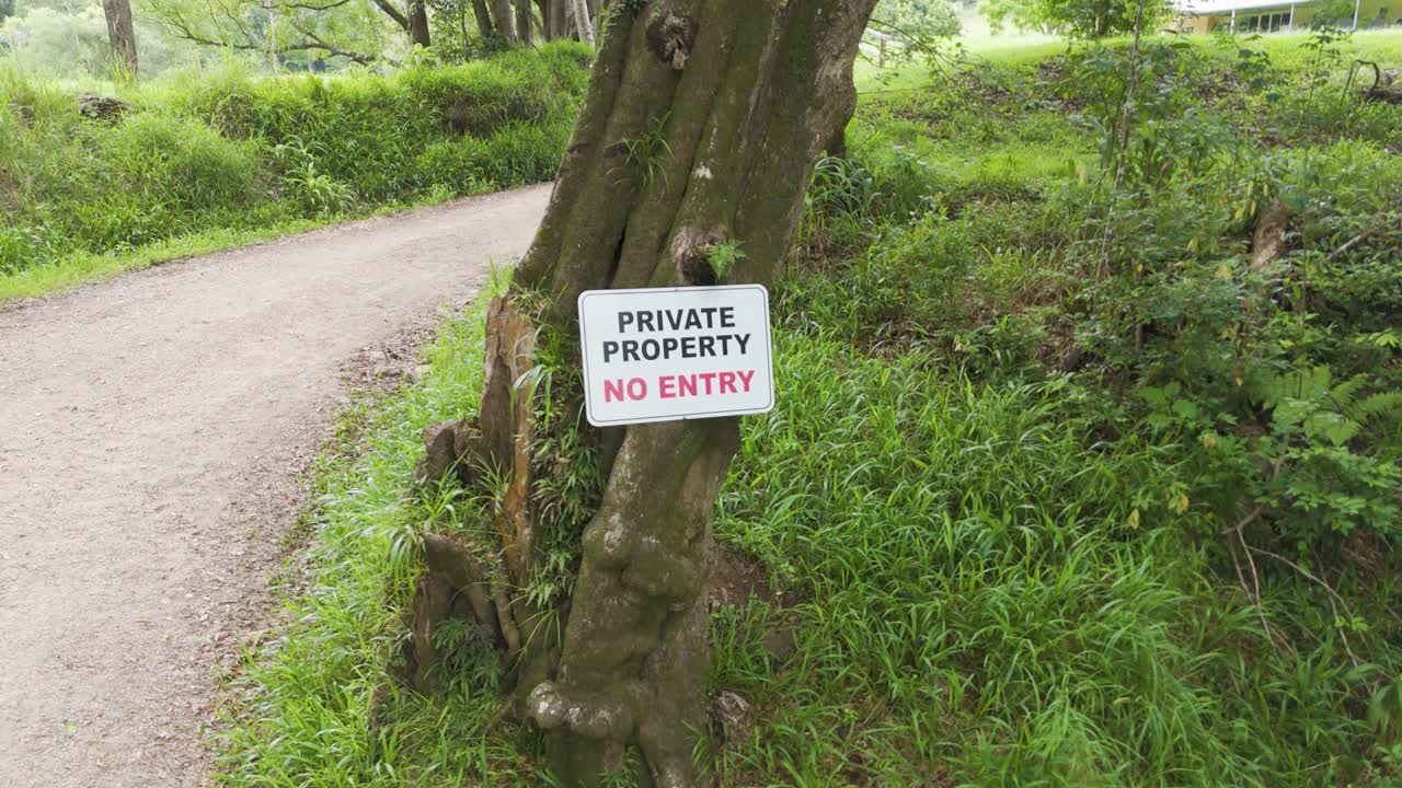 Drone pans over a private property sign