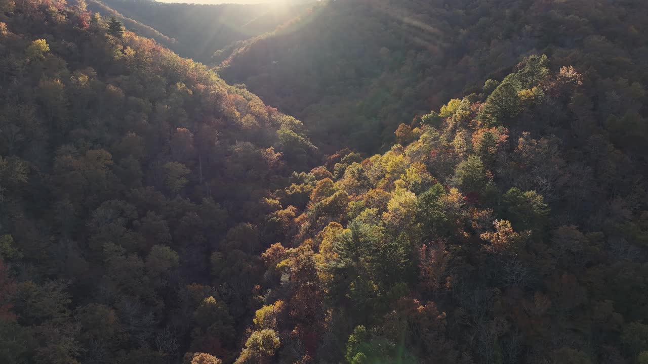Drone view of sunsetting over hills and mountains