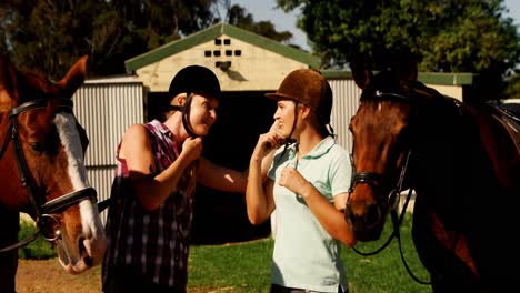 friends interacting while wearing protective helmet in ranch 4k