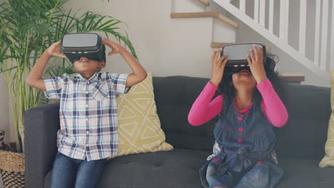 African-american-siblings-wearing-vr-headsets-and-having-fun