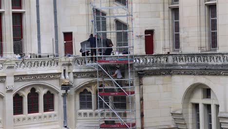 restoration workers on scaffolding at castillo de pierrefonds, france, castle preservation