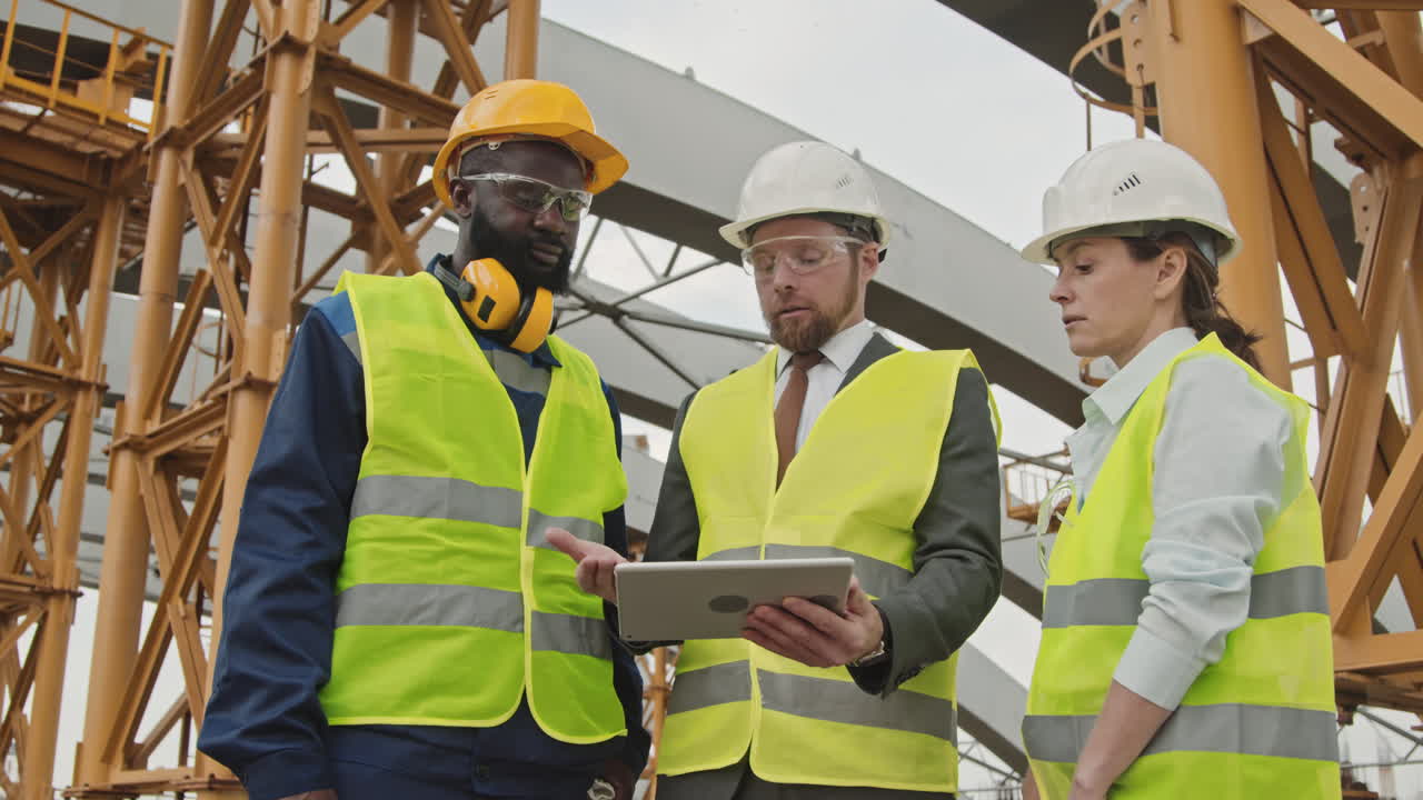 Site Supervisor Instructing Construction Workers