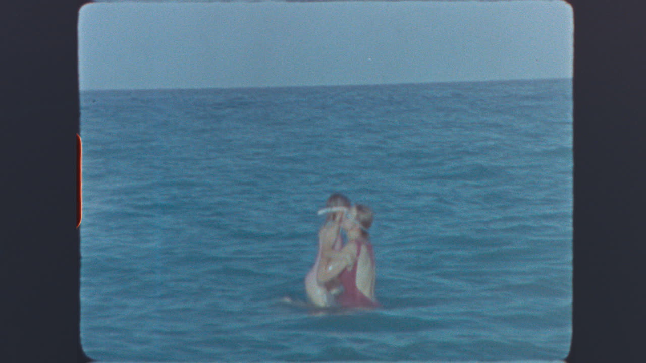 Vintage Super 8 Footage of People Swimming and Splashing in the Ocean