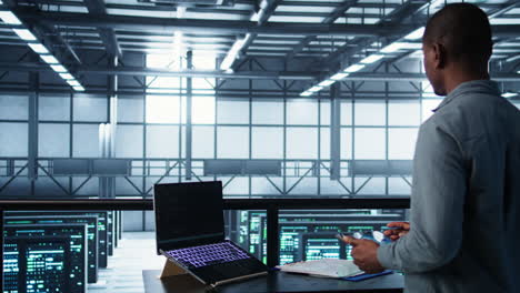 técnico en un centro de datos con portátil y tableta que integra tecnología de ia