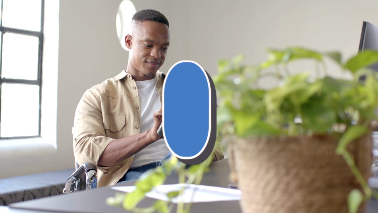 Man tapping tablet in bright office, blue likes overlays cycling counts, showing social metrics