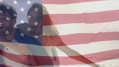 Caucasian-couple-hugging-with-US-flag-waving-foreground