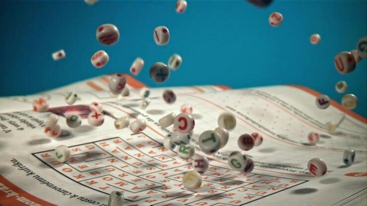 Slow Motion Letter Beads Falling onto a Crossword Puzzle