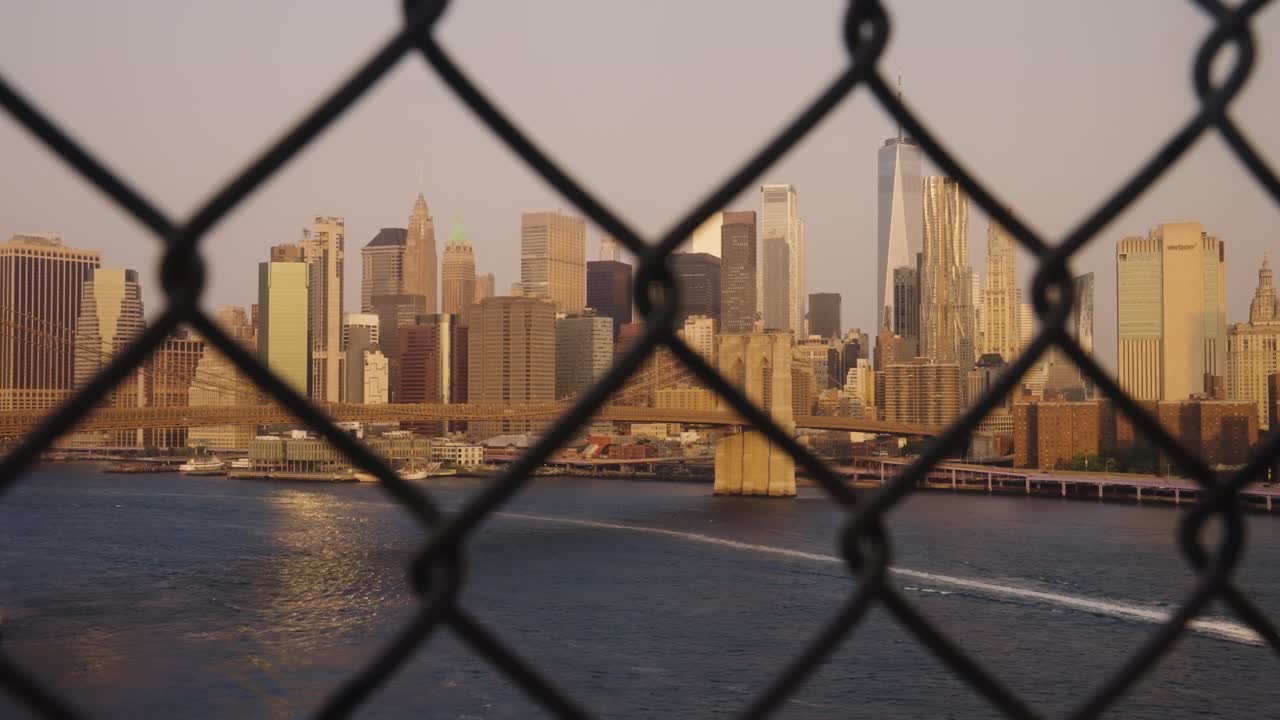 Panning shot of Golden Skyline behind fence in New York City, Usa - Panoramic wide shot