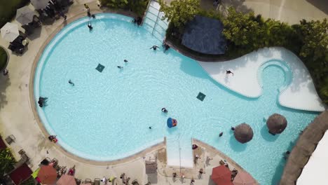 aerial view of a beautiful resort pool with people enjoying the day