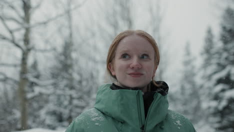 smiling teen girl in a snow-covered forest