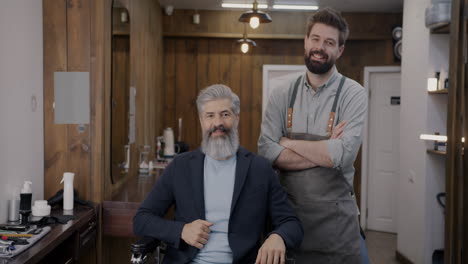 happy customer and barber in a stylish barber shop