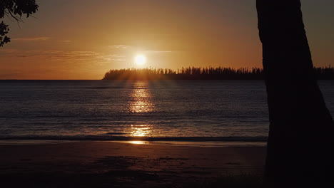 slow tracking shot of beautiful golden sunset on kuto beach, isle of pines