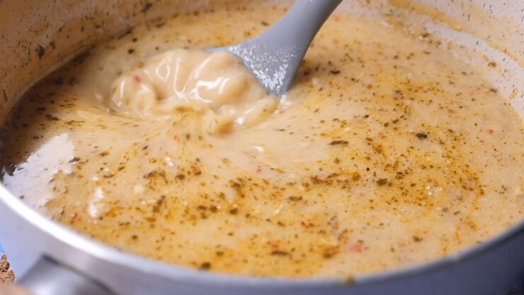 Close-up of Creamy Soup Being Stirred with a Ladle
