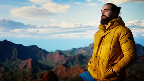 determined explorer gazes at the endless sky and towering peaks