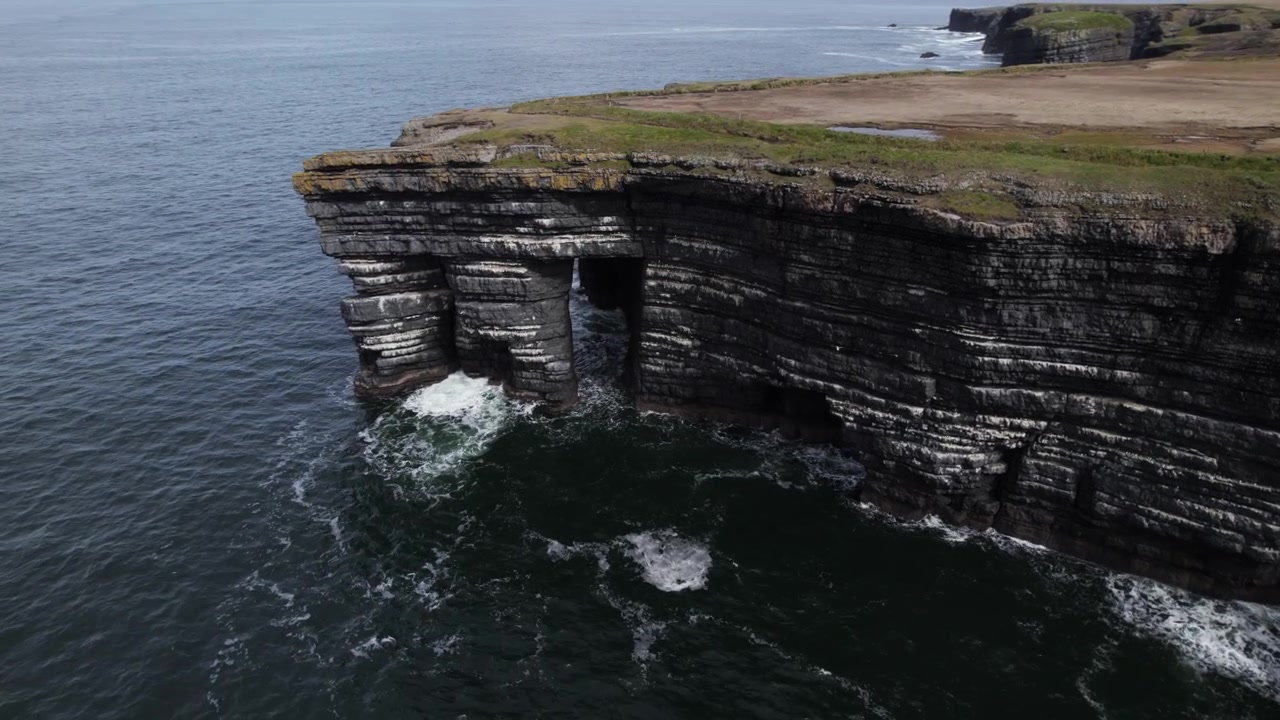 Drone Shot of Scenic Atlantic Ocean Coast of Ireland, Steep Cliffs and Arch Under Coastal Pastures