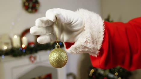 santa claus holding christmas bauble ball